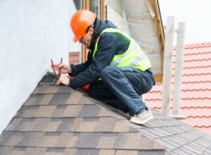 Roofer Builder Worker Dismantling Roof Shingles in San Jose, CA